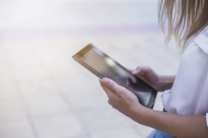 garota usa tablet para ler livro digital